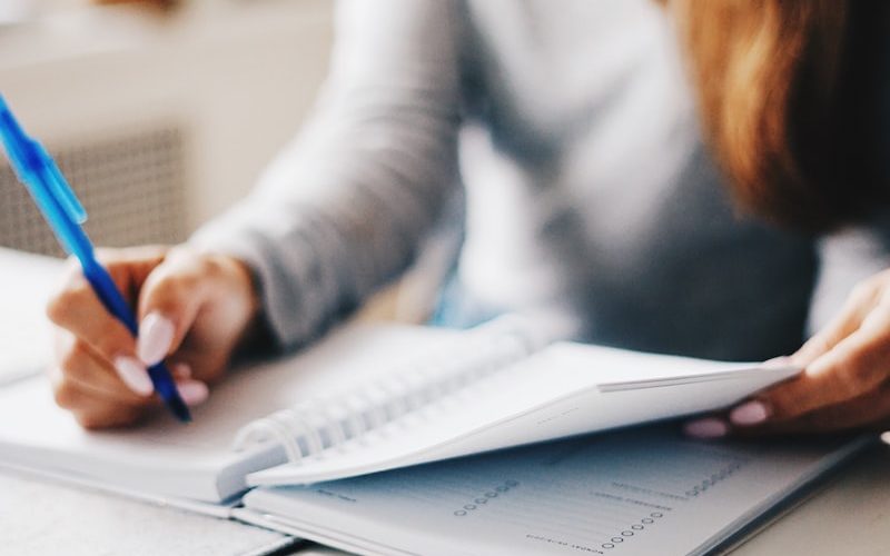 woman writing using pen