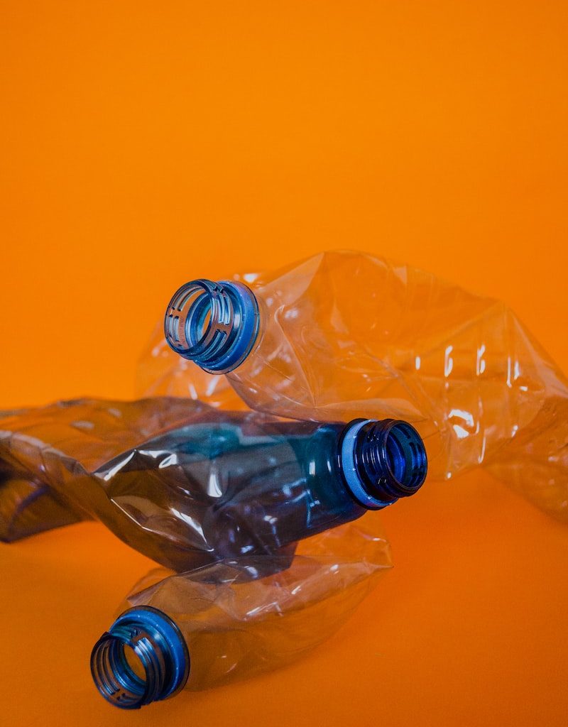 blue plastic bottle on orange surface