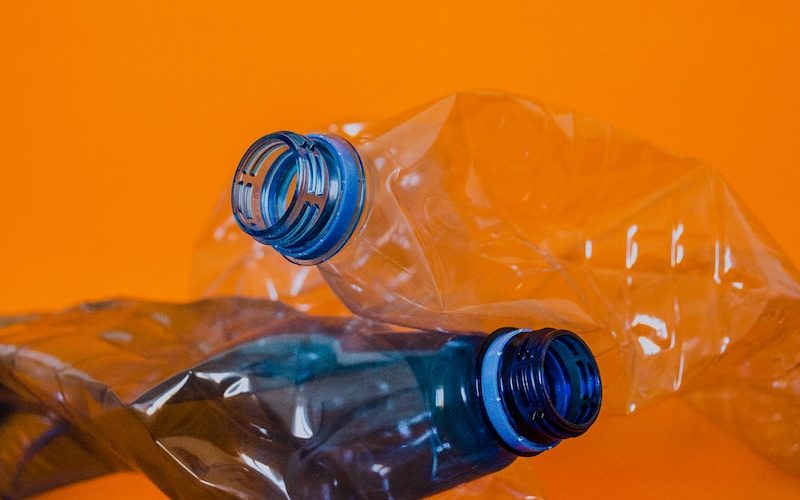 blue plastic bottle on orange surface