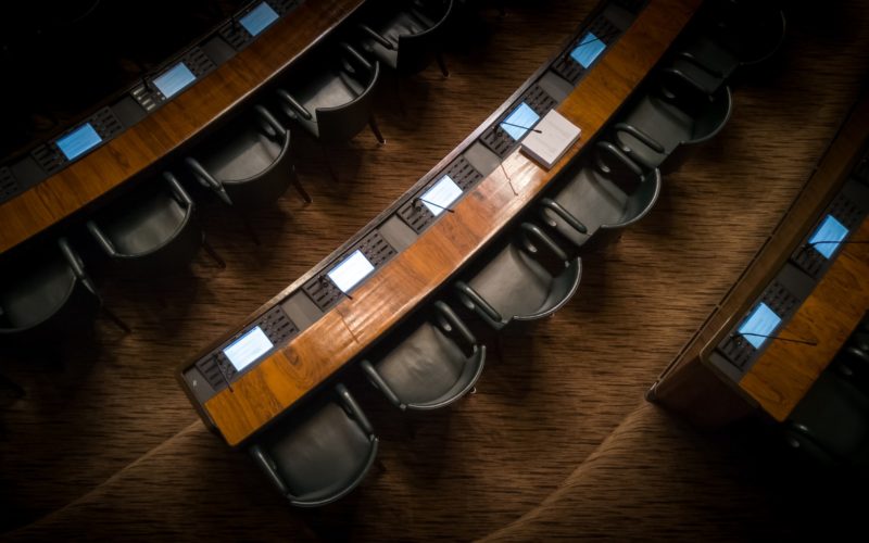 low light photography of armchairs in front of desk