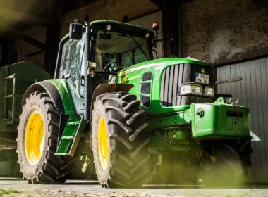 green and yellow tractor in garage
