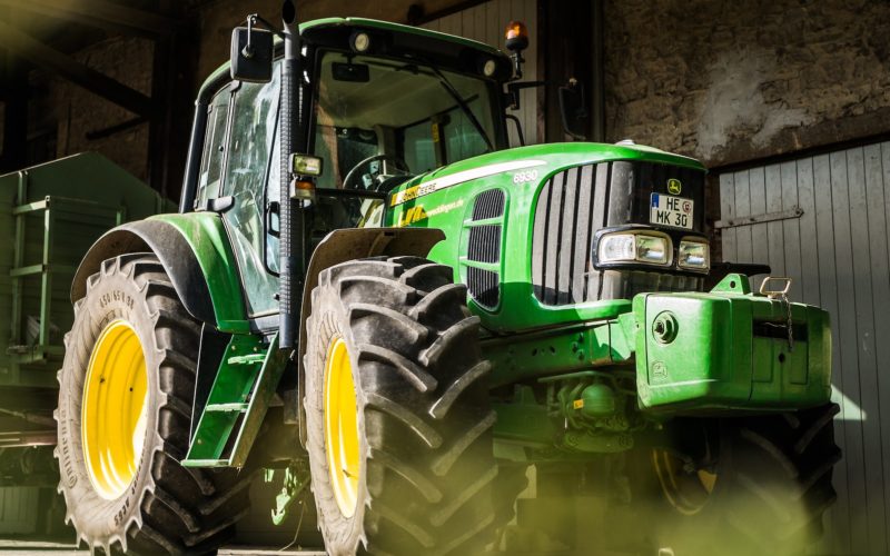 green and yellow tractor in garage