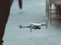 white and red drone flying