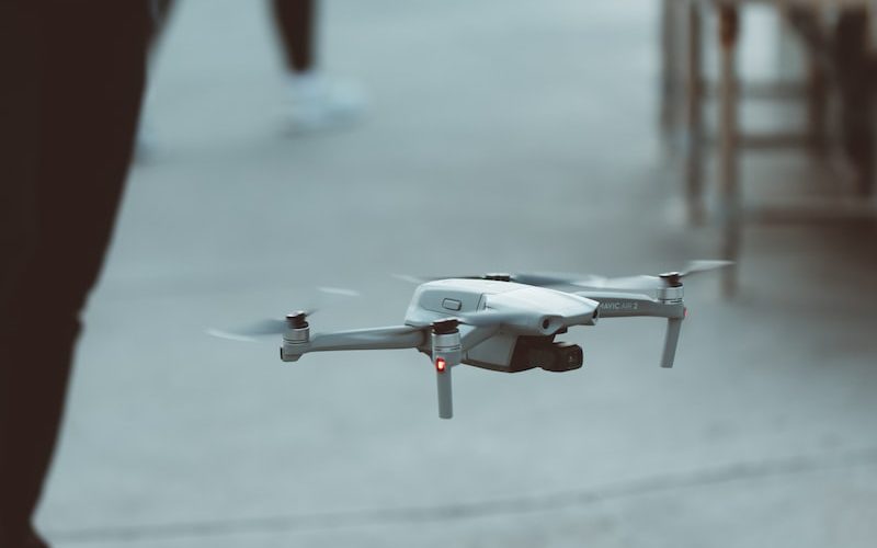 white and red drone flying