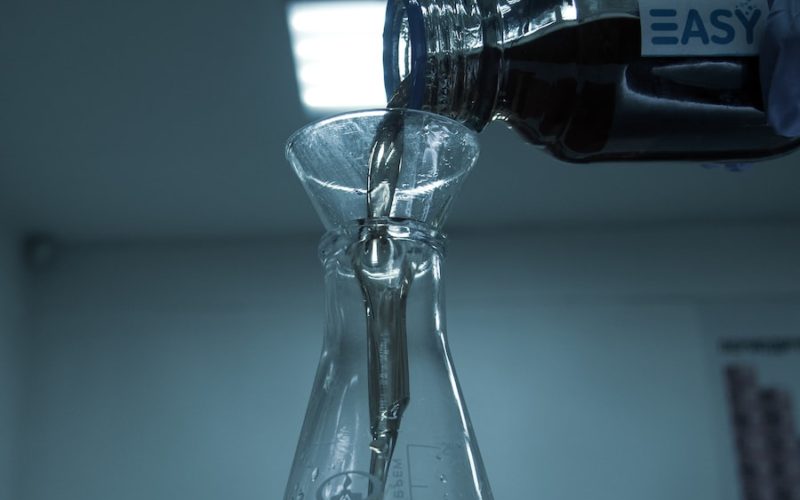 clear glass bottle on white table