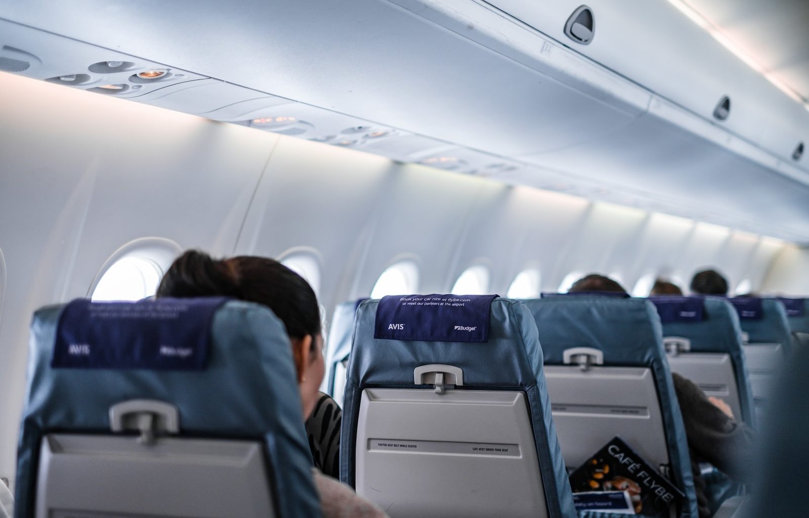 people sitting on gray and white airplane seats