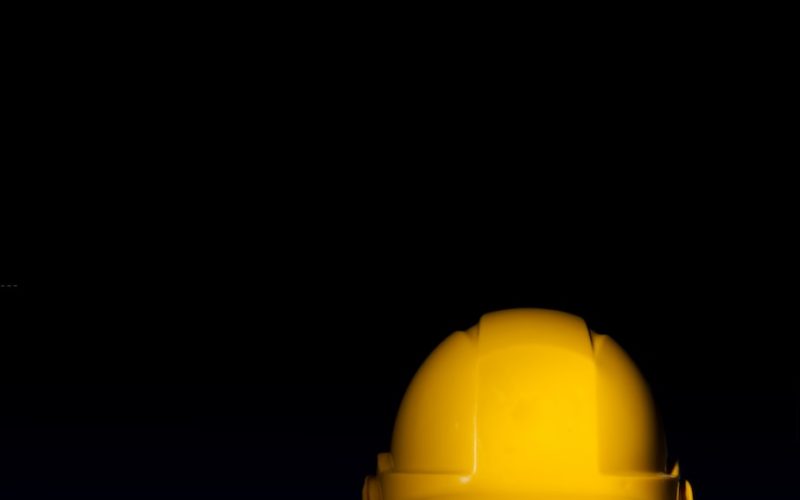 yellow safety hat on black surface