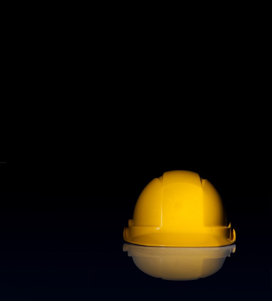 yellow safety hat on black surface